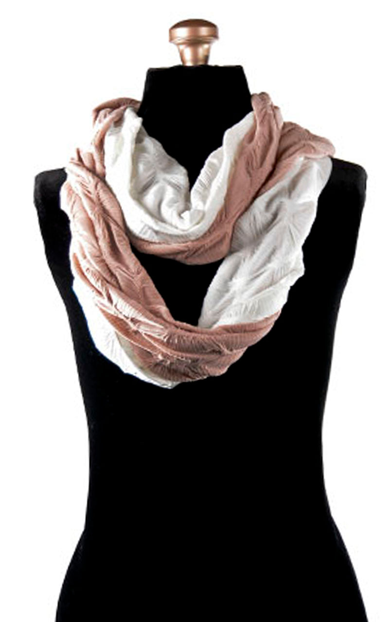Product shot of Women’s Infinity Loop Scarf | Entangled Romance in Dusty Rose and Cloud, a lightweight, knit covered in gathers in pink and ivory| Handmade in Seattle WA | Pandemonium Millinery