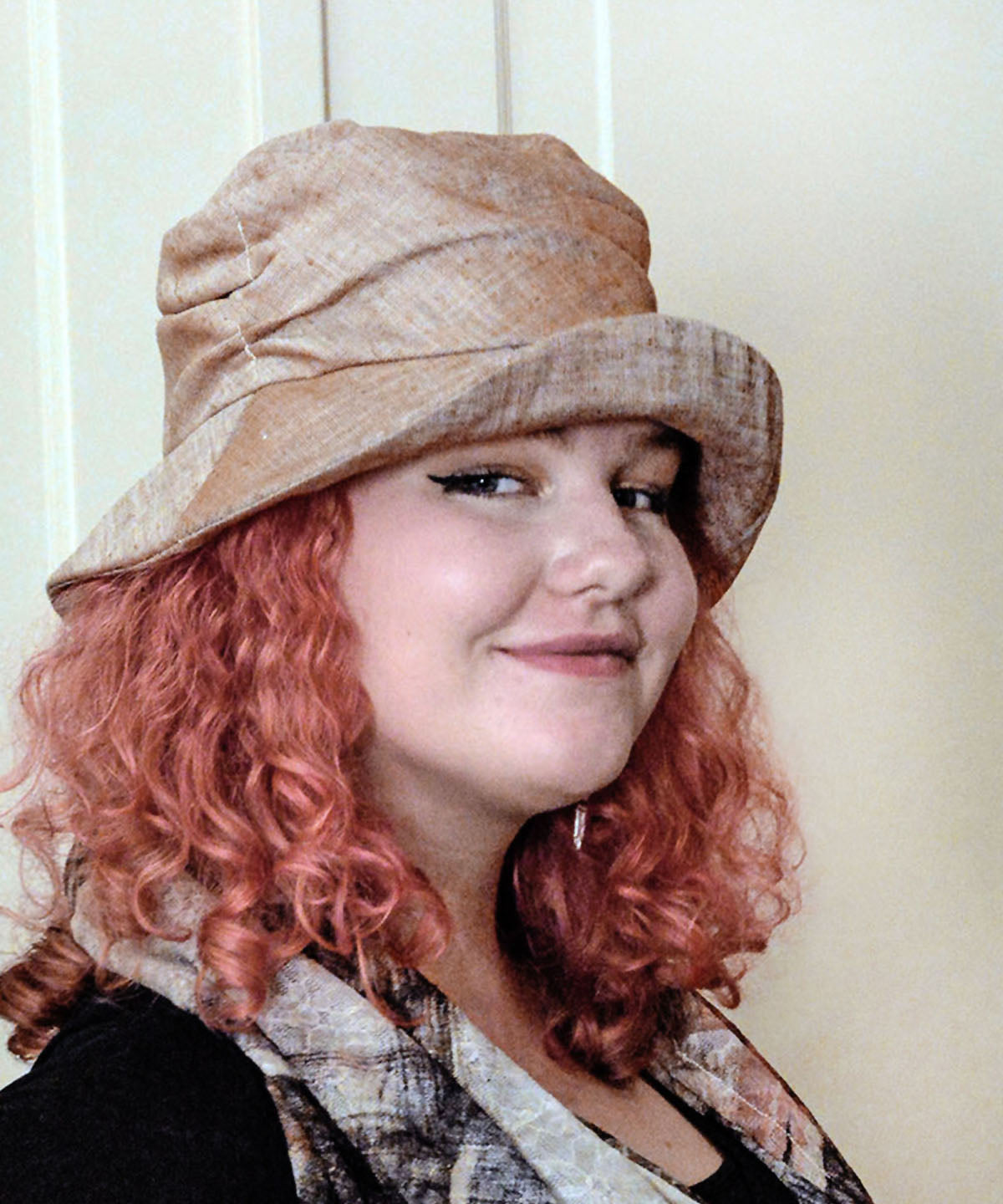 Woman wearing Cuffed Krystyne Bucket Hat in Coral Linen Handmade in Seattle WA by Pandemonium Millinery USA