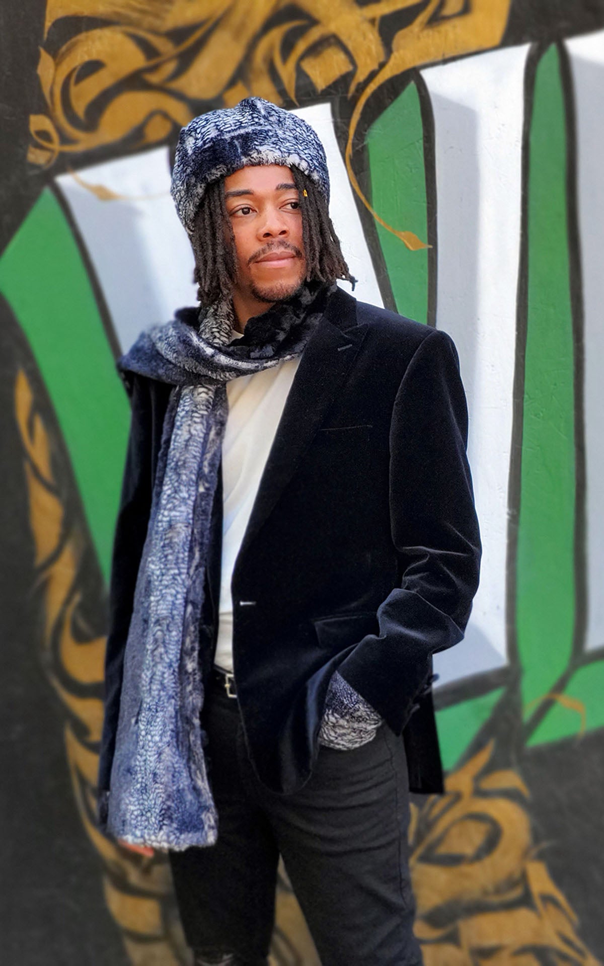  Male Model wearing beanie matching hat and  Classic Scarf against graffiti wall | Black Mamba animal snake print with Cuddly Black Faux Fur | Handmade by Pandemonium Millinery Seattle, WA USA