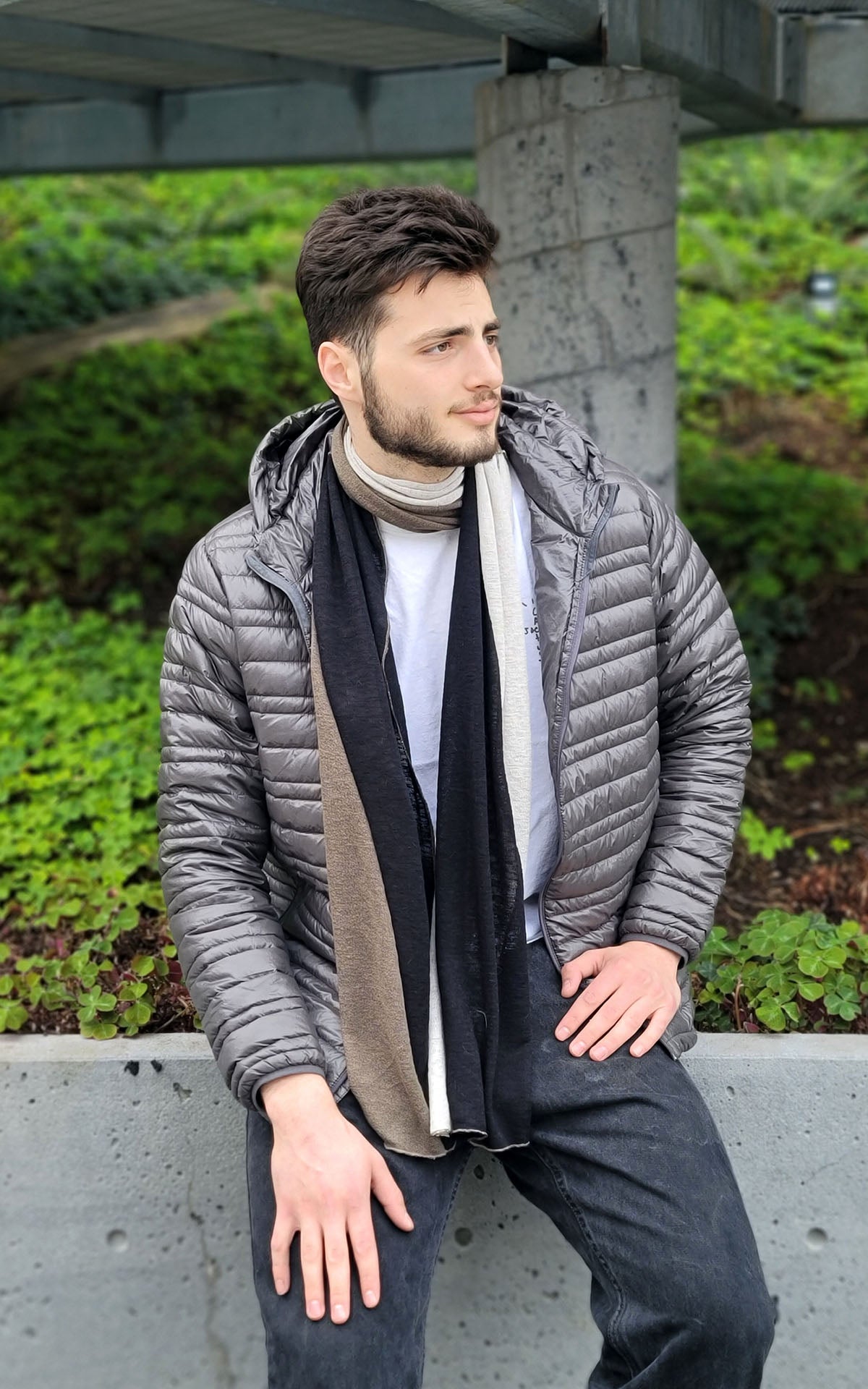 Man wearing the Upcycled Motley Scarf in the large pattern, and colors are Mezcal, Sandstone and Scorpion. Handmade by Pandemonium Seattle.