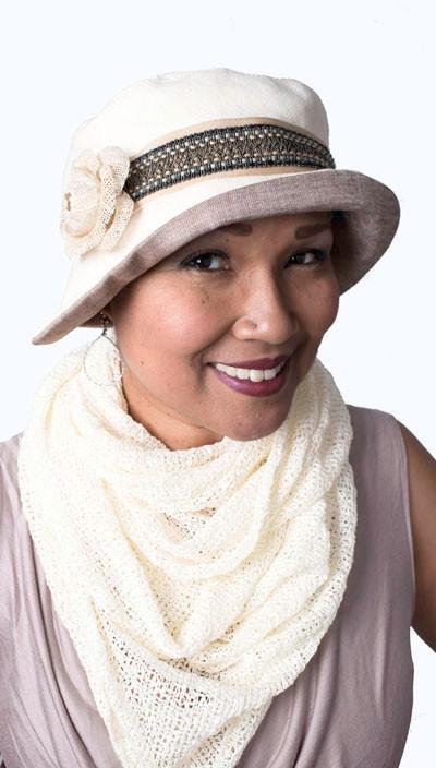 Woman wearing Abigail Hat in Seashell Cream Linen with Braided Band and trimmed with Cream Flower. Handmade in Seattle WA| Pandemonium Millinery 