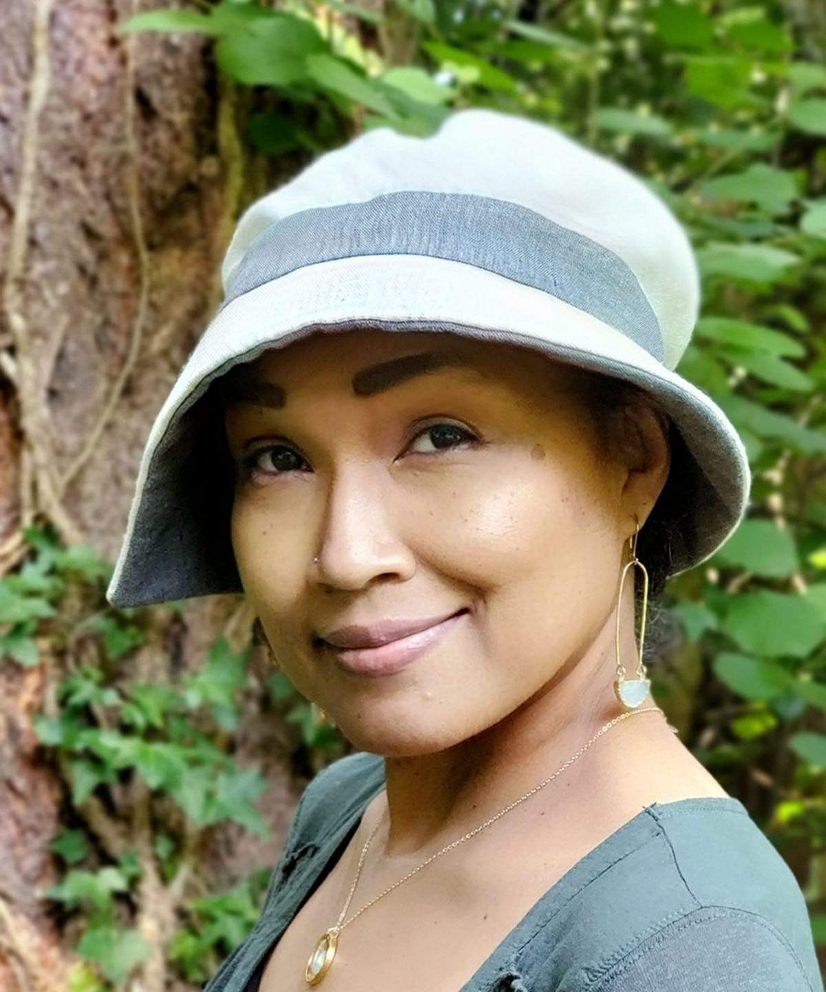 Woman wearing Abigail Hat in Seashell Cream Linen with Juniper Green under trim and  Band. Handmade in Seattle WA| Pandemonium Millinery 