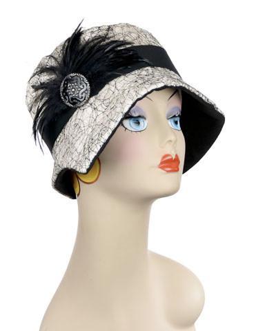 Woman wearing Abigail Hat in White Luna pattern with Black Band. Trimmed with Black Feather and Black Button. Handmade in Seattle WA| Pandemonium Millinery 