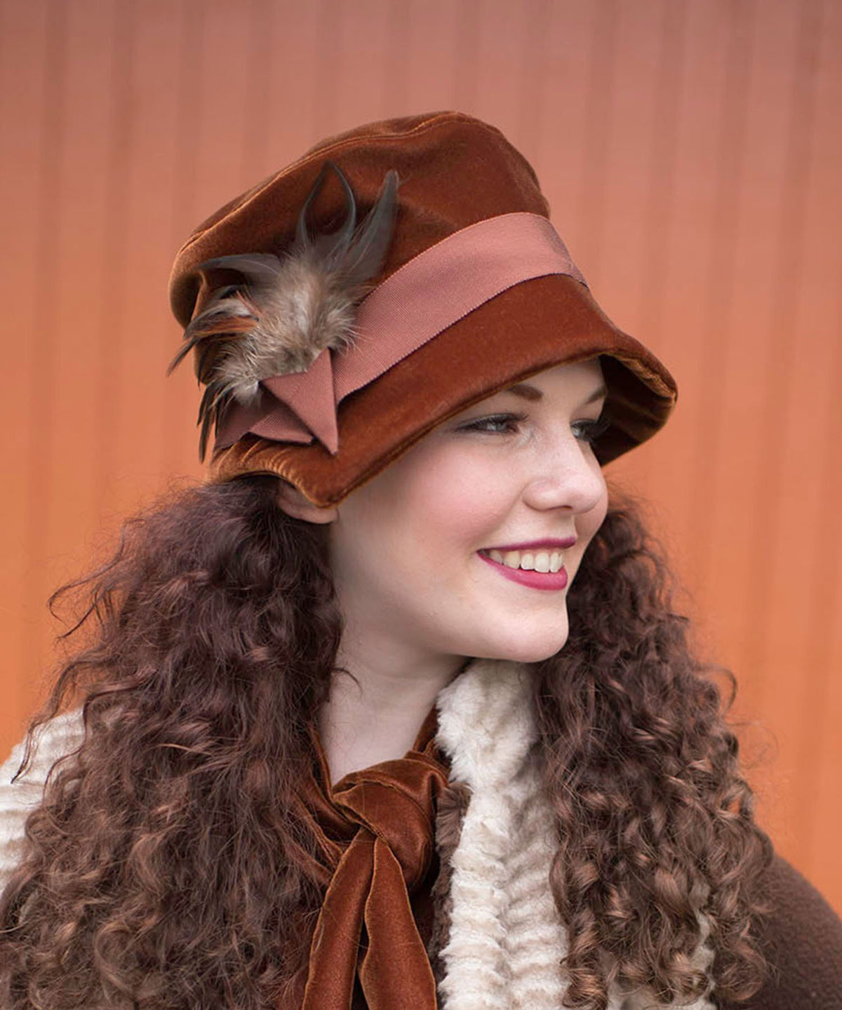 Side view of woman wearing Abigail Hat in Citrine Velvet with Rust Grosgrain Band and Pheasant Feathers| Handmade in Seattle WA| Pandemonium Millinery 