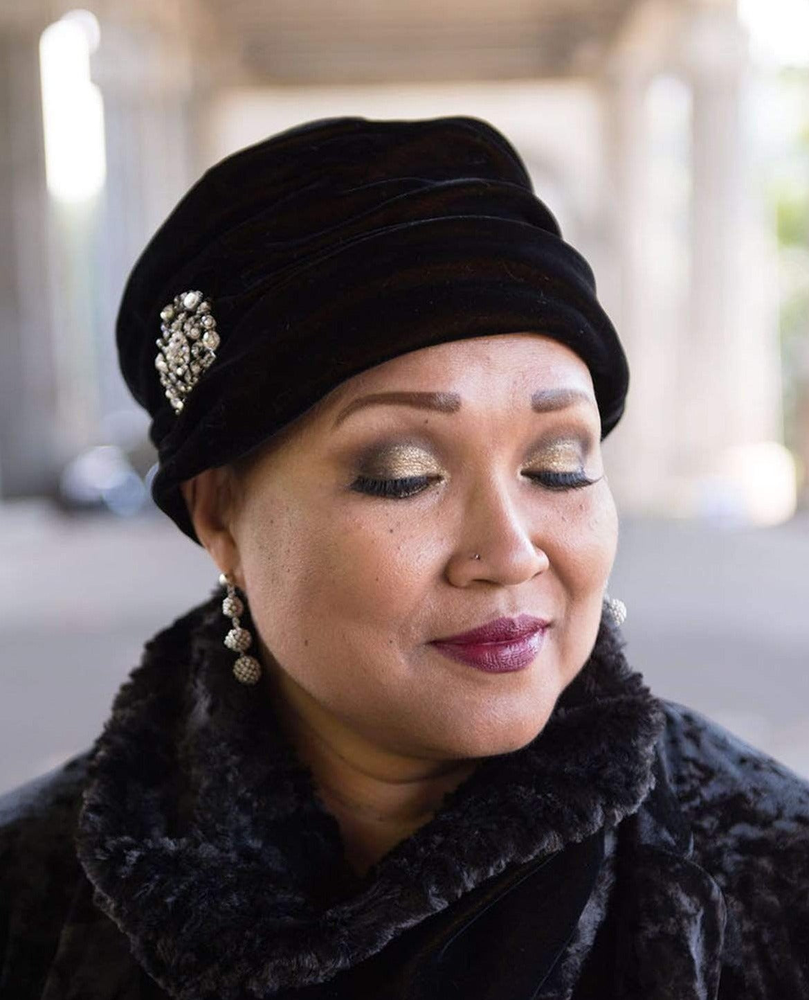 Close up of woman wearing Ana Cloche Hat in Black Velvet with Rhinestone Brooch| Handmade in Seattle WA| Pandemonium Millinery