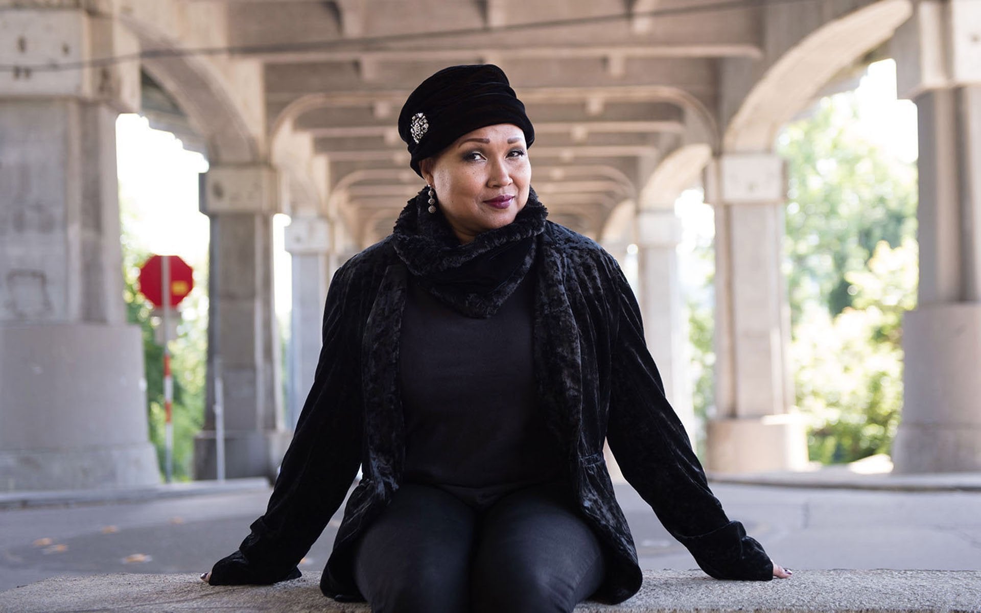 Close up of woman wearing Ana Cloche Hat in Black Velvet with Rhinestone Brooch| Handmade in Seattle WA| Pandemonium Millinery