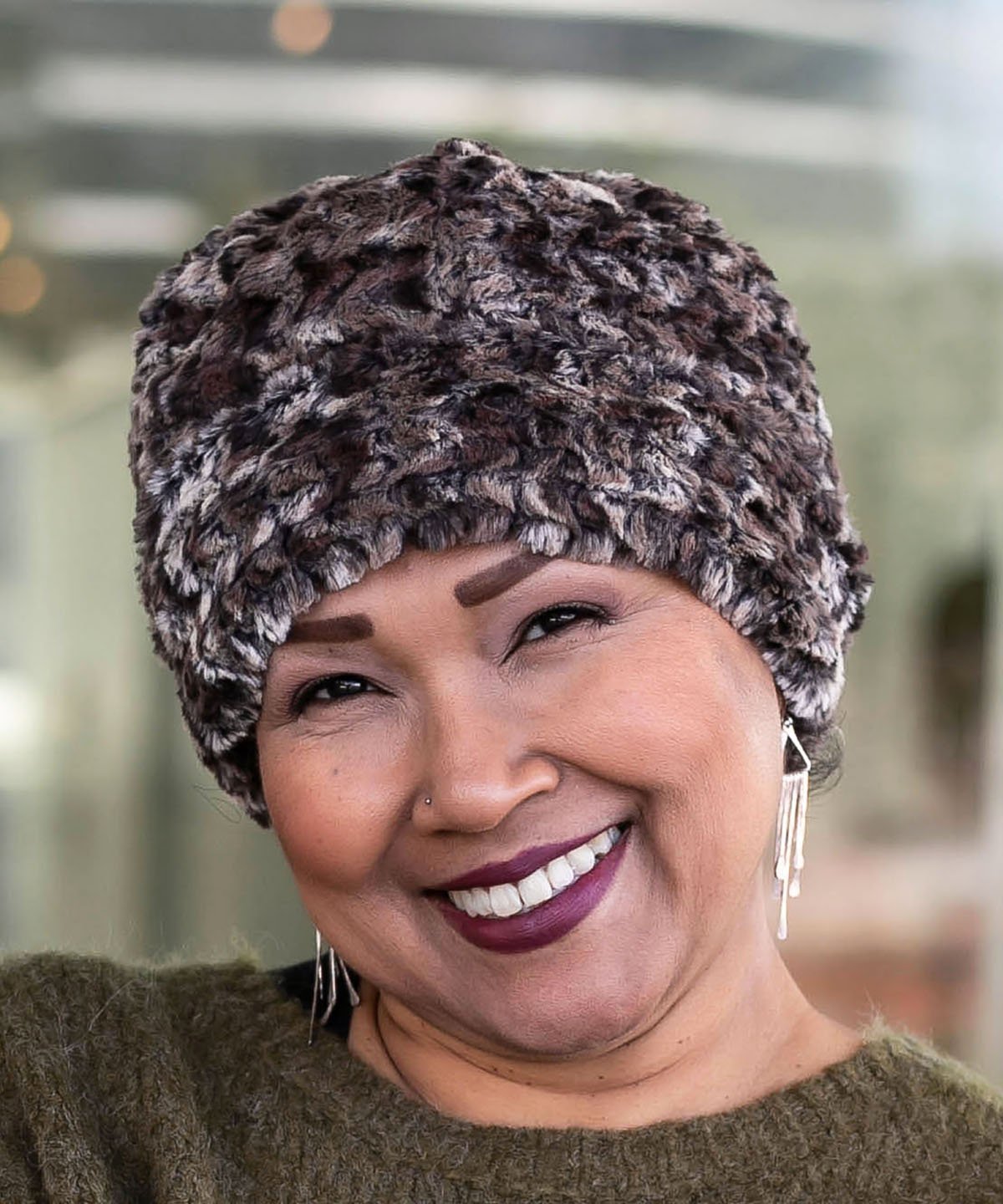 Woman modeling Beanie Hat reversible in Calico and Cuddly Chocolate Faux Fur, shown uncuffed. Handmade by Pandemonium Millinery in Seattle, WA.