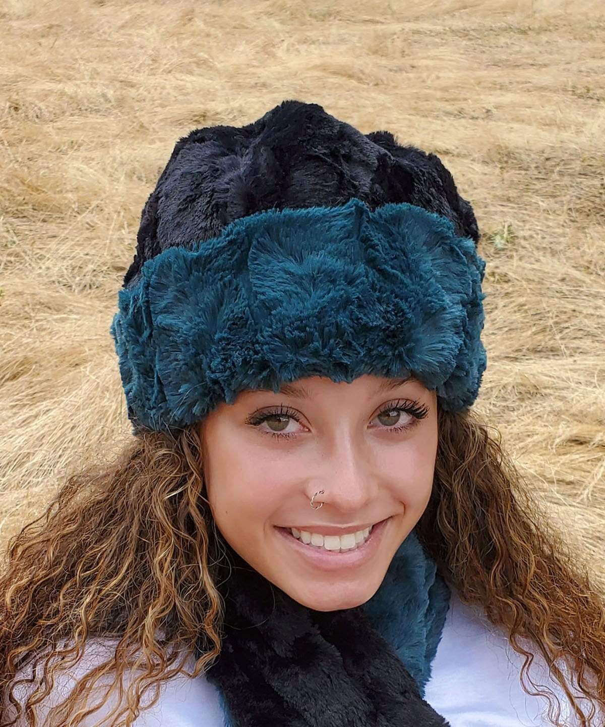 Woman modeling Beanie Hat, shown reversed in Luxury Faux Fur – Peacock Pond and Cuddly Black. Pandemonium Millinery in Seattle, WA.