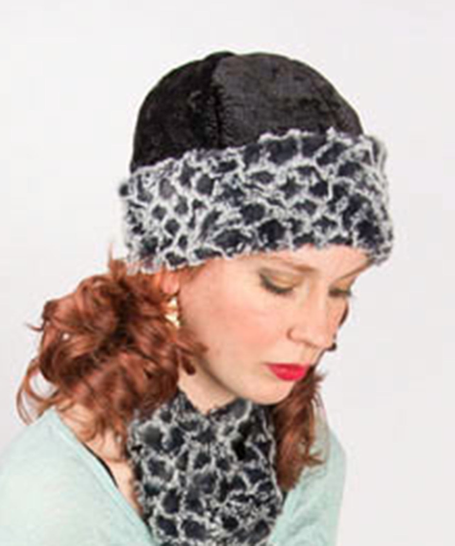 Woman modeling Beanie Hat in structured Black Pebbles lined and cuffed with Snow Owl Faux Fur. Handmade by Pandemonium Millinery.