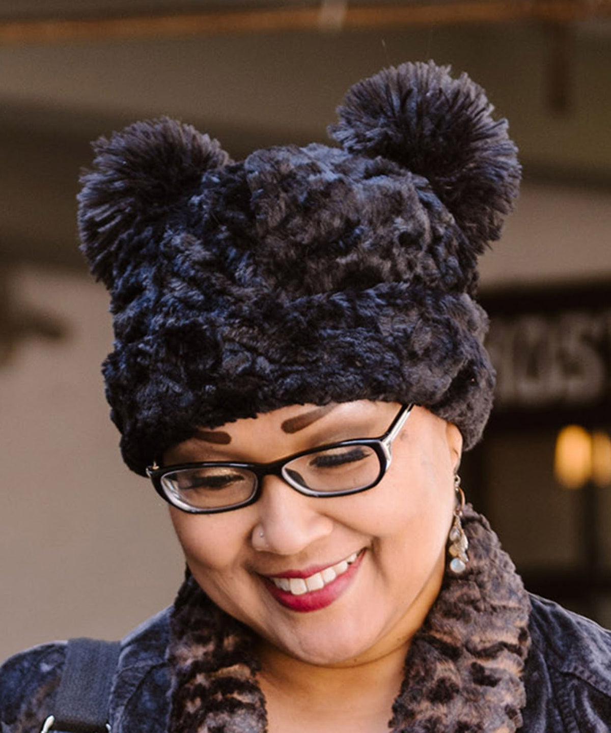 Woman modeling Bear Beanie Hat with ears, in Cuddly Black Faux Fur lined with Chocolate. Handmade by Pandemonium Millinery.