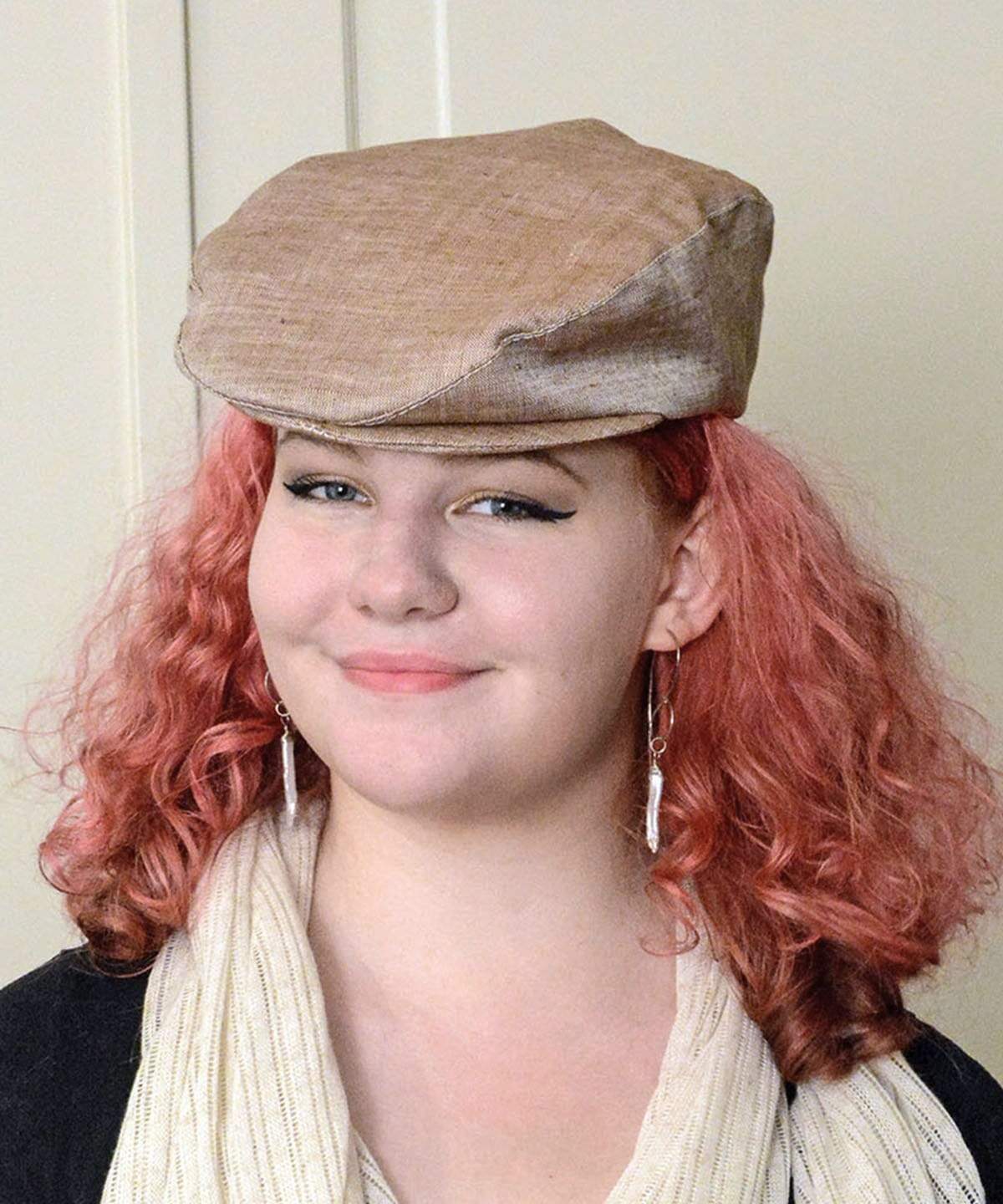 Woman wearing Pandemonium Millinery Charlie Driving Cap | Linen in Coral| Handmade in Seattle WA