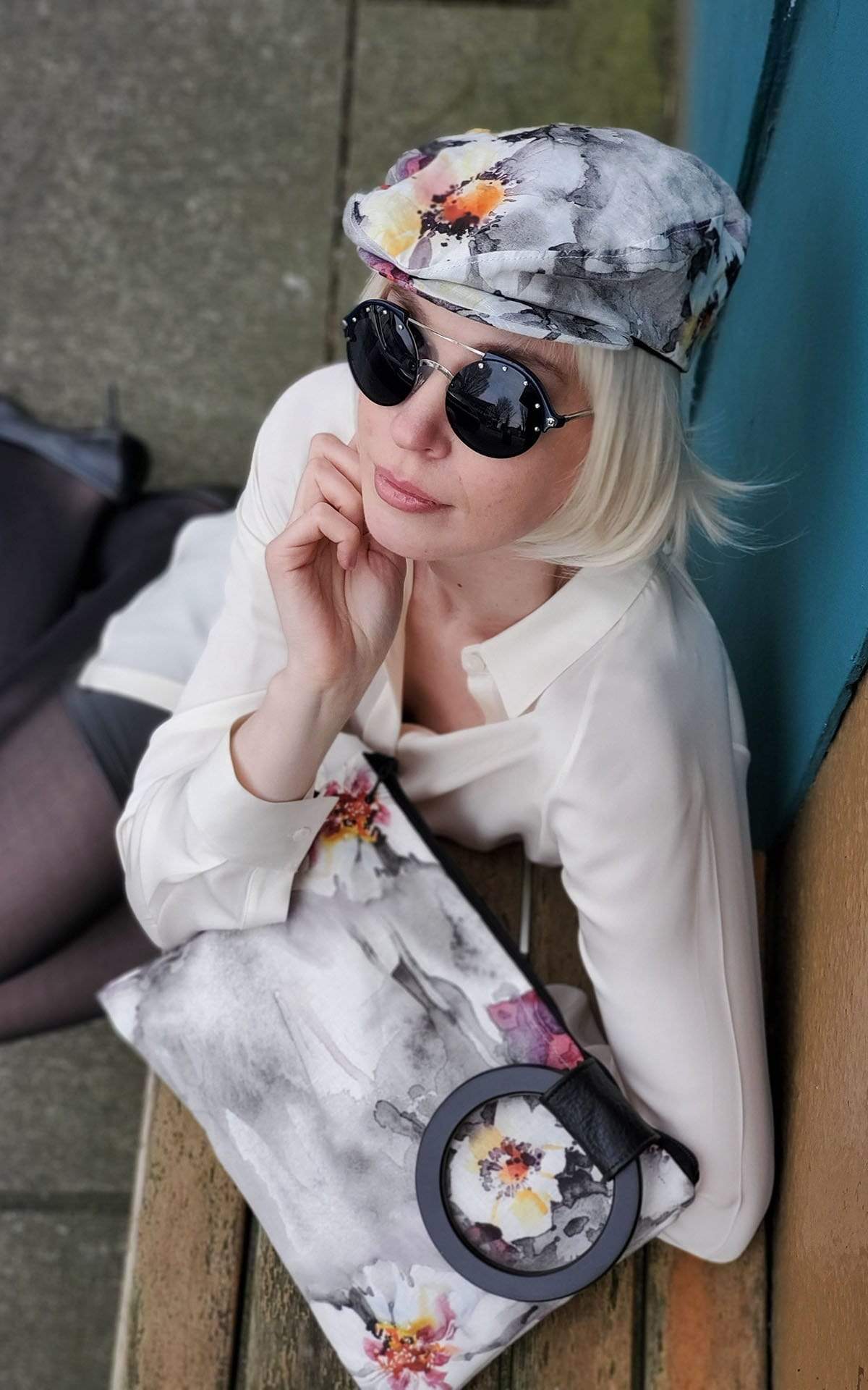 Woman wearing Pandemonium Millinery Charlie Driving Cap | Linen in Multi-Floral | Handmade in Seattle WA