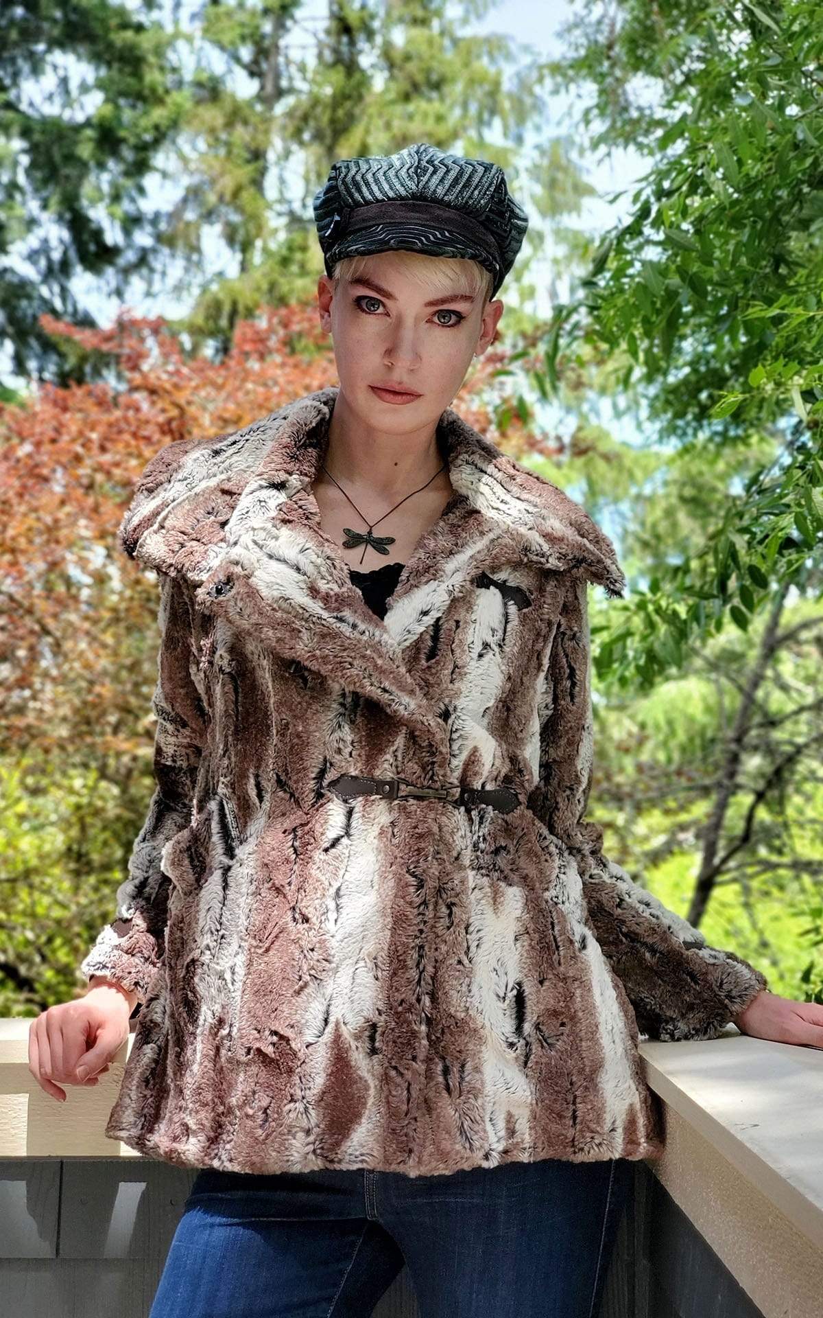 Model leaning on a wood railing Dietrich Coat | Birch Brown and Ivory Faux Fur Pea Coat | Featuring Buckle Clasps | Handmade in Seattle, WA | Pandemonium Millinery