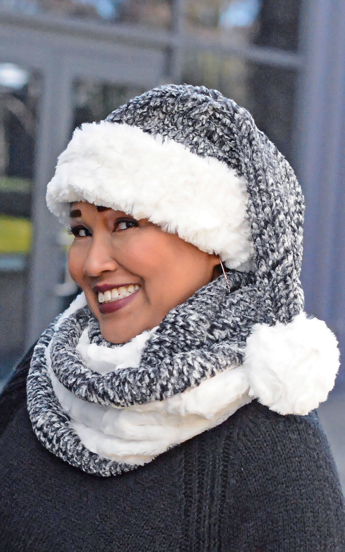Model wearing Women&#39;s Double Cowl Shrug looped twice around neck | Cozy Cable in Ash Faux Fur with Cuddly Ivory and Matching Santa Hat | Handmade in Seattle WA | Pandemonium Milliner