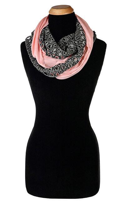 Ladies Two-Tone Infinity Scarf on Mannequin | Lunar Landing, a black and neutral knit with curled edges surrounding holes, paired with a light-weight Jersey Knit  Pink Jersey Knit | Handmade in Seattle WA | Pandemonium Millinery