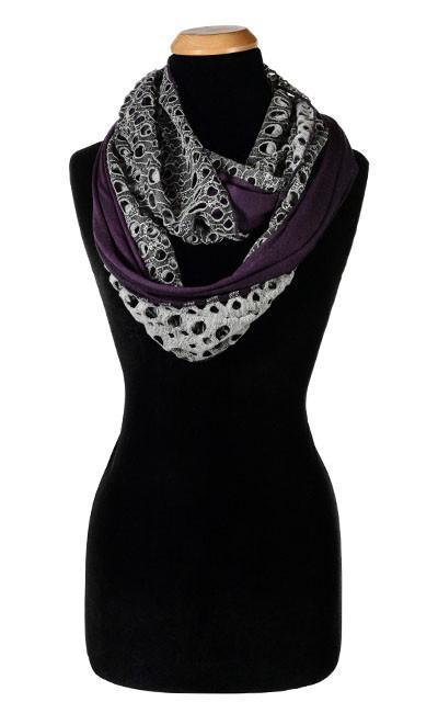 Ladies Two-Tone infinity Scarf on Mannequin | Lunar Landing, a black and neutral knit with curled edges surrounding holes, paired with a light-weight lime purple Jersey Knit | Handmade in Seattle WA | Pandemonium Millinery
