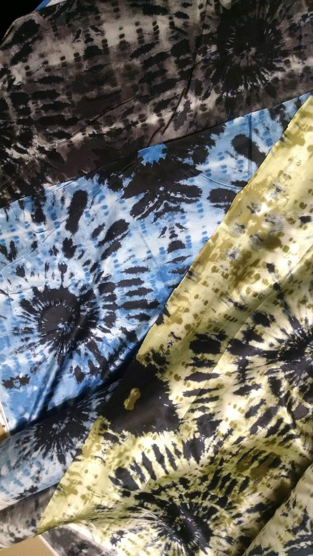 3 color ways of the Egyptian Oasis fabrics layd out on table 