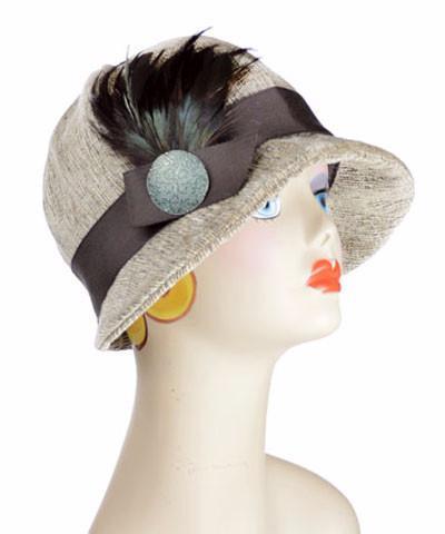 Product Shot of the Grace Cloche Hat in Bongo Beige upholstery fabric, with additional feather brooch and button. Handmade in Seattle, WA, USA by Pandemonium Seattle.'