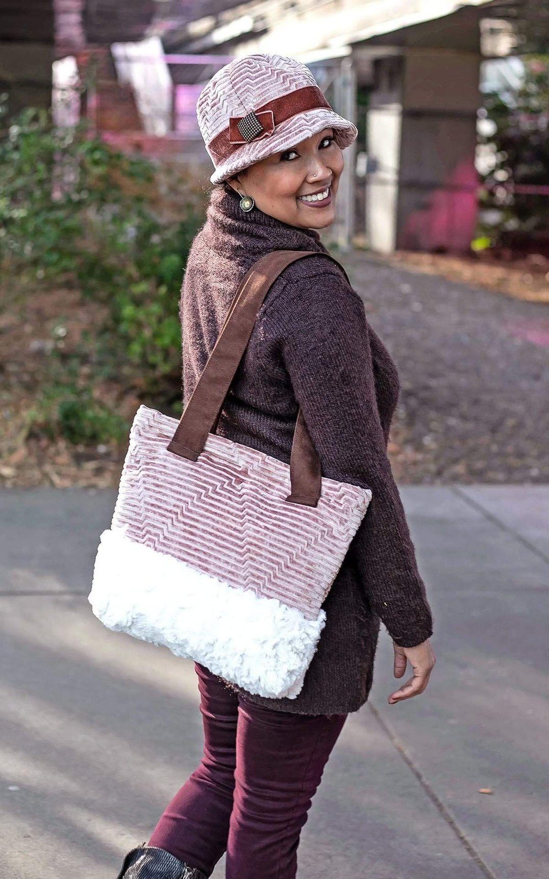 Full Body Shot of Model wearing a Grace Style 1920s Cloche and Matching Tote Bag |  Hat Fabric is  Chenille in Cherry Blossom with Rouge pink Velvet Band and Bow with a Copper Square Button Trim | Bag Fabric Features Faux Leather Handles and Chenille and Faux Faux Body By Pandemonium Millinery | Seattle WA USA
