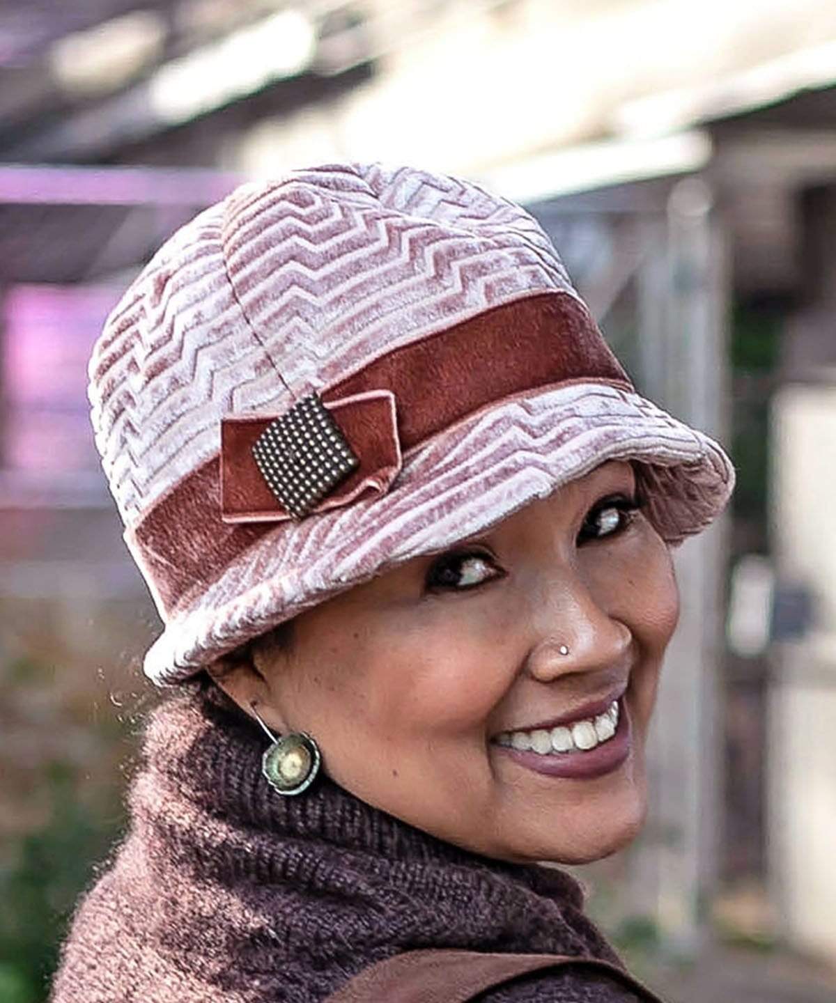 Close Up of Model wearing  a Grace Style 1920s Cloche in Chenille in Cherry Blossom with Rouge pink Velvet Band and Bow with a Copper Square Button Trim | By Pandemonium Millinery | Seattle WA USA
