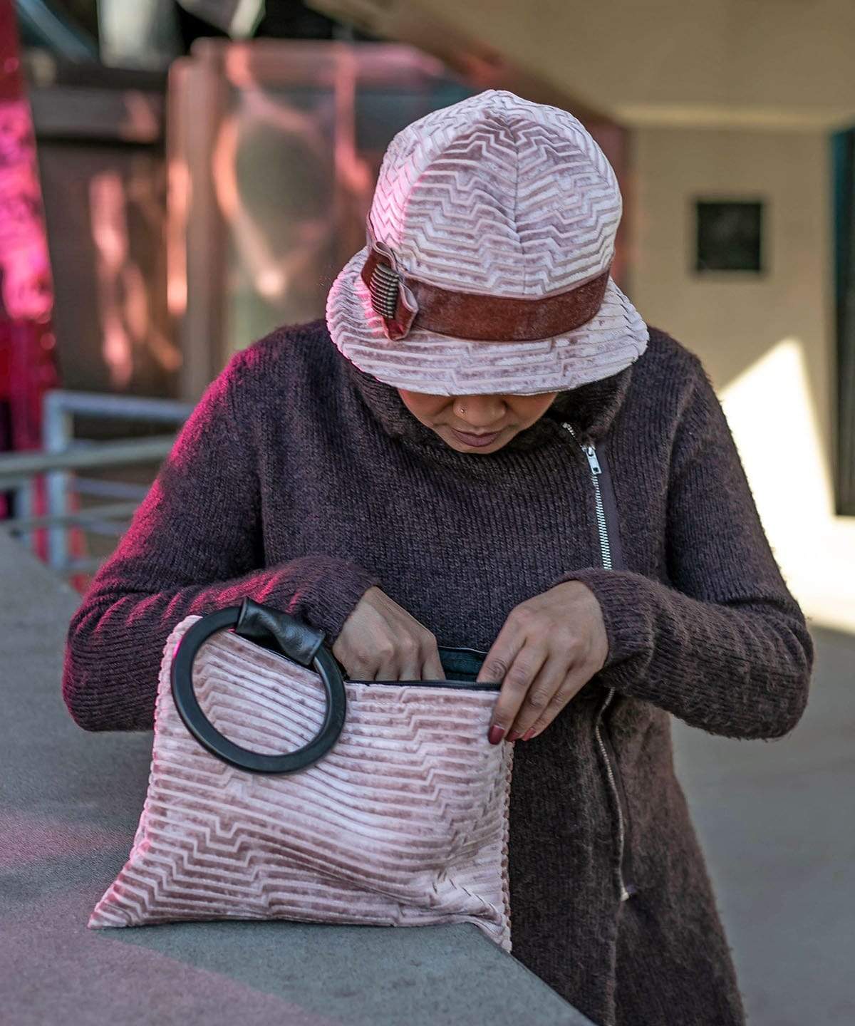 Model wearing a Grace Style 1920s Cloche in Chenille in Cherry Blossom with Rouge pink Velvet Band and Bow with a Copper Square Button Trim | Paris Bag in Chenille Cherry Blossom eatured |By Pandemonium Millinery | Seattle WA USA