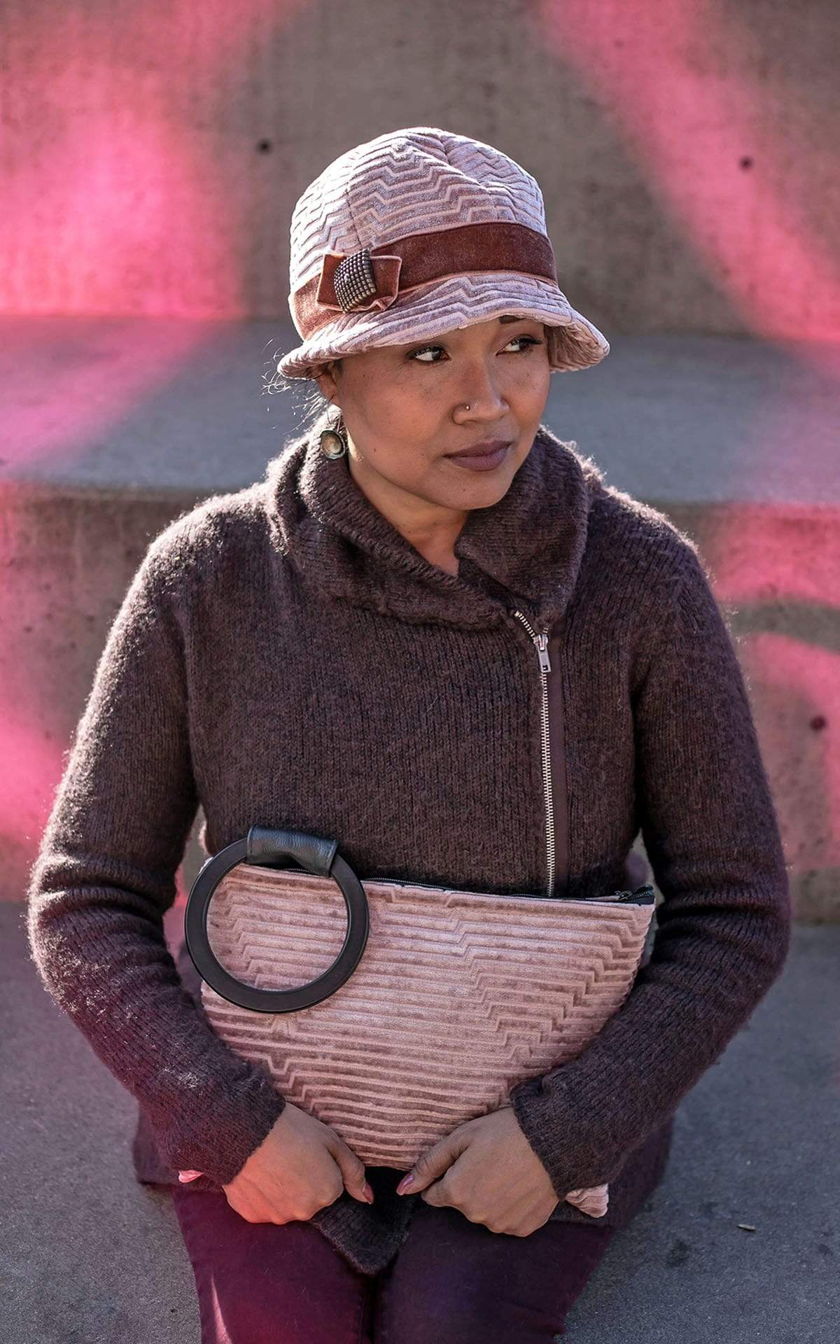 Model wearing a Grace Style 1920s Cloche in Chenille in Cherry Blossom with Rouge Pink Velvet Band and Bow with a Copper Square Button Trim | Model also holding a Paris Bag in Chenille Cherry Blossom eatured |By Pandemonium Millinery | Seattle WA USA