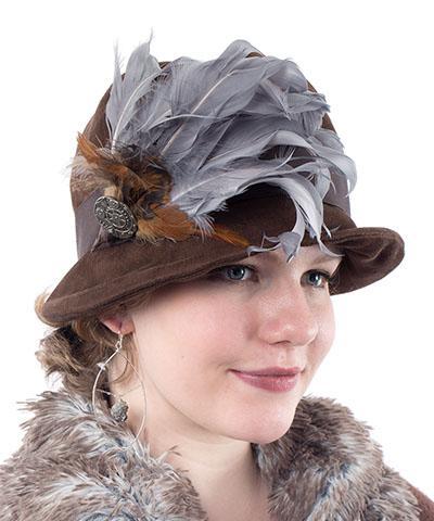 Close Up of Model wearing Grace Cloche Hat in Faux Suede Chocolate | Chocolate Grosgrain Band, a Silver and Rooster Feather Brooch featuring a Silver Button | Pandemonium Millinery | Seattle WA USA