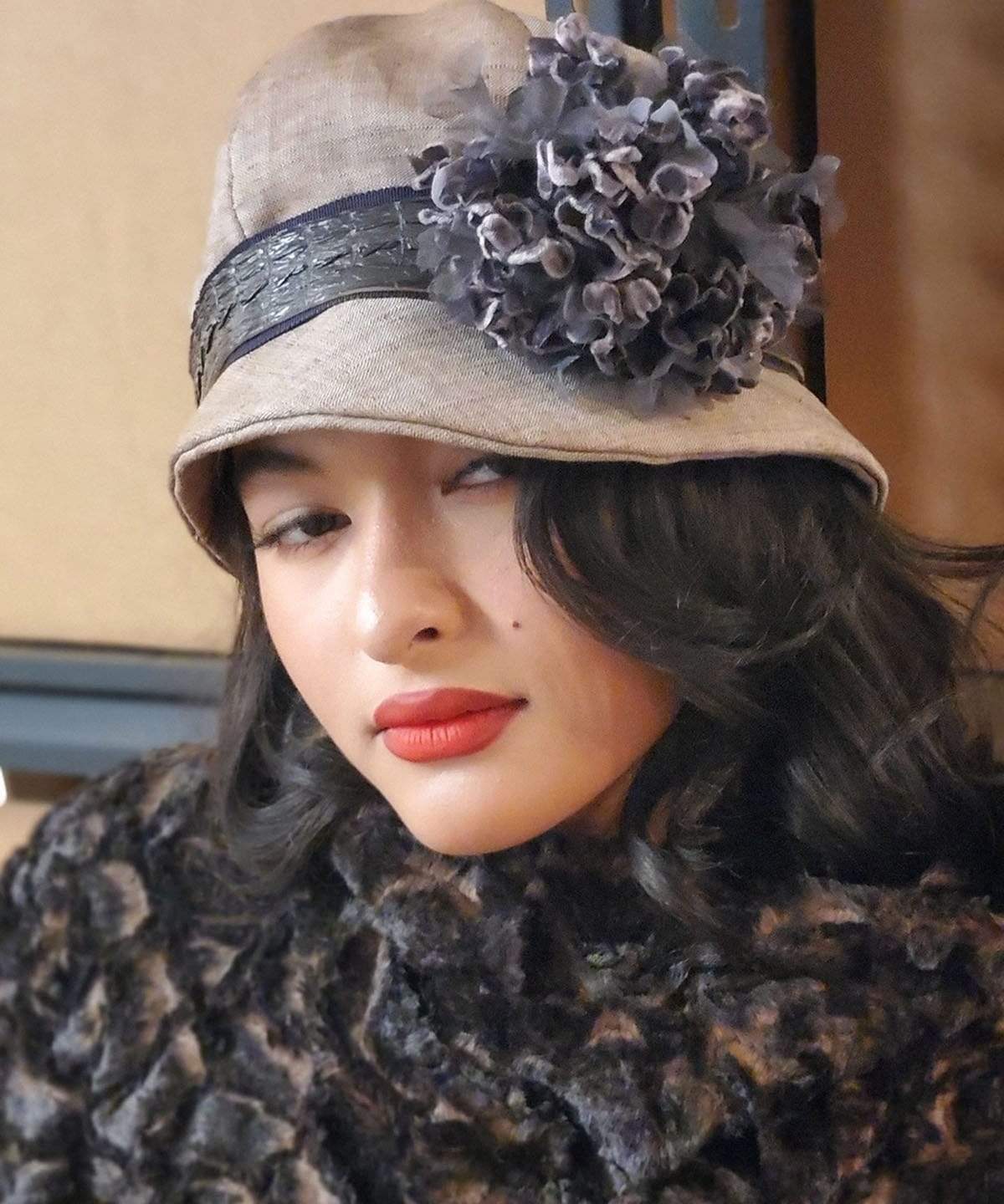 Model wearing Grace Cloche Linen in Coral  with  Faux Croc Band and Custom Purple Multi Flower Brooch | Handmade By Pandemonium Seattle | Seattle WA USA