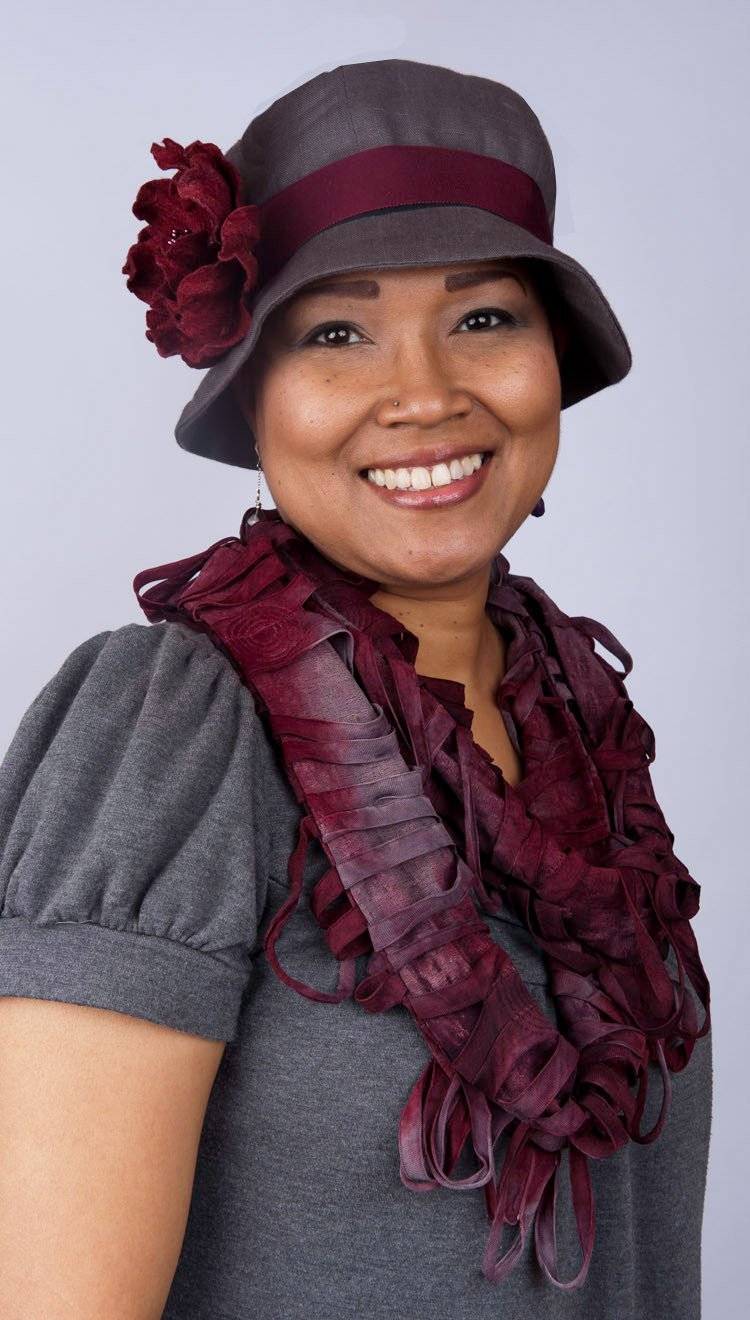  Woman wearing Grace Cloche Linen in Gray with Burgundy Flower Brooch and Grosgrain Band | Handmade By Pandemonium Millinery | Seattle WA USA