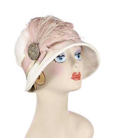 Grace Cloche Style Hat Linen in Seashell Featuring Carination Grosgrain Band and Pink feather Brooch with Hand Painted Button | By Pandemonium Millinery | Seattle WA US