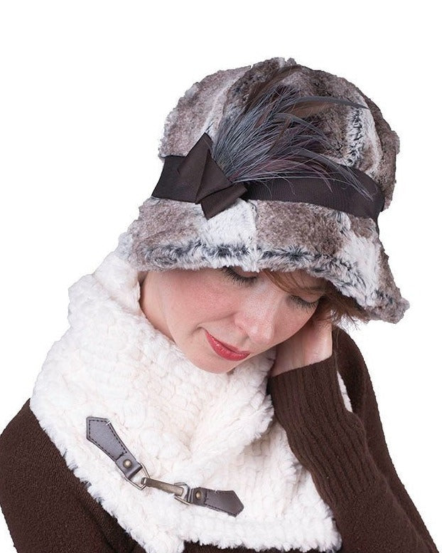 Front view of Model wearing  Grace Cloche in Luxury Faux Fur in Birch with Chocolate Grosgrain Band featuring a Feather Brooch| Handmade in Seattle WA By Pandemonium Millinery