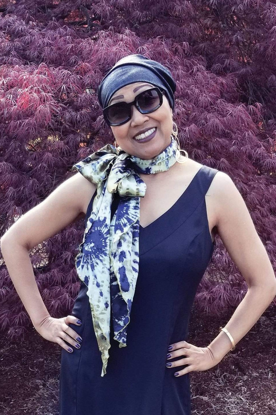 Women’s sitting on the grass holding a scarf over her head, Large Handkerchief Scarf, Wrap | Egyptian Mirage, black, Blues, and ivory tie-dye | Handmade in Seattle WA | Pandemonium Millinery