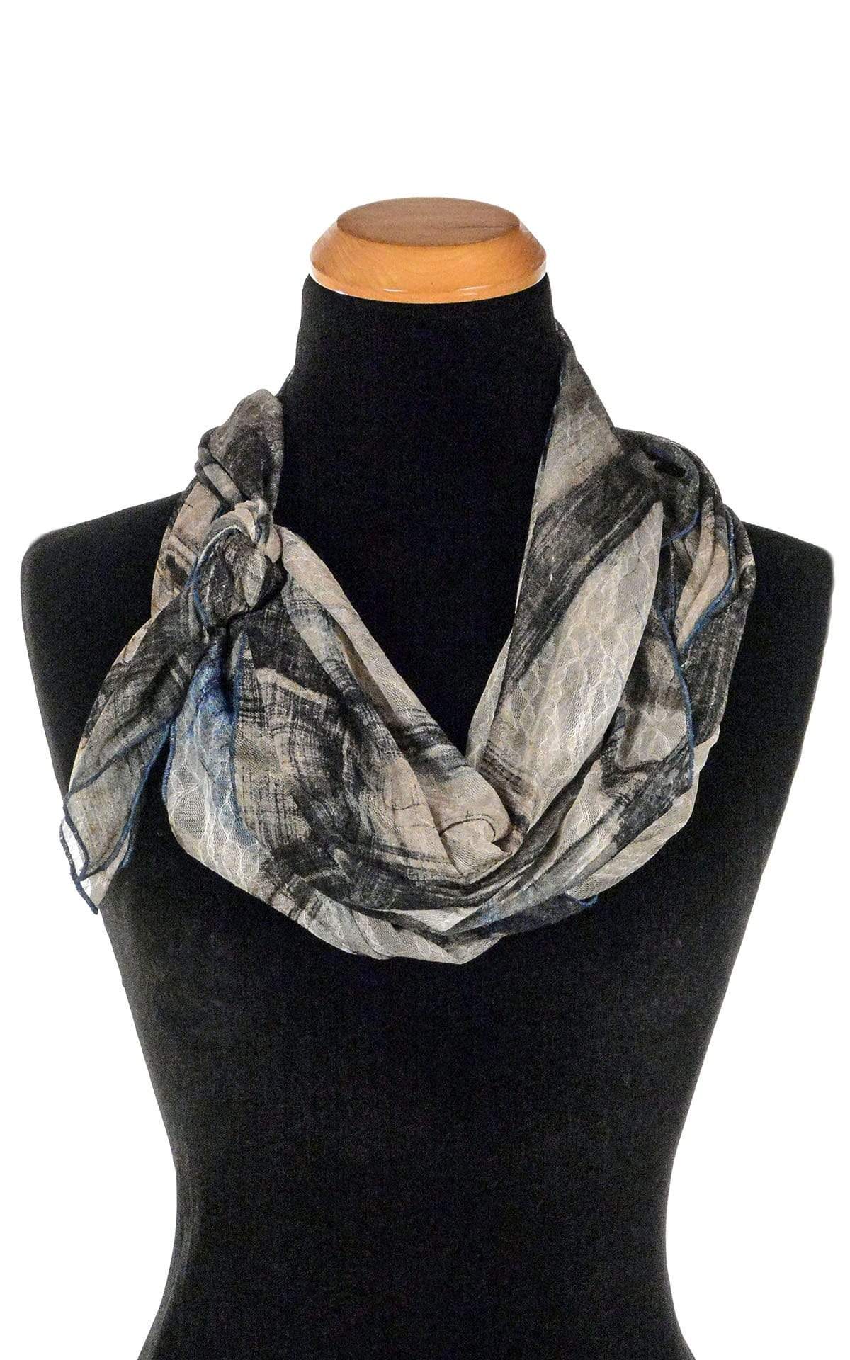 Women’s Large Handkerchief Scarf, Wrap on Mannequin double wrapped shown tied | Lovely Lace in Blue, a blue/beige/black print on sheer lace knit | Handmade in Seattle WA | Pandemonium Millinery