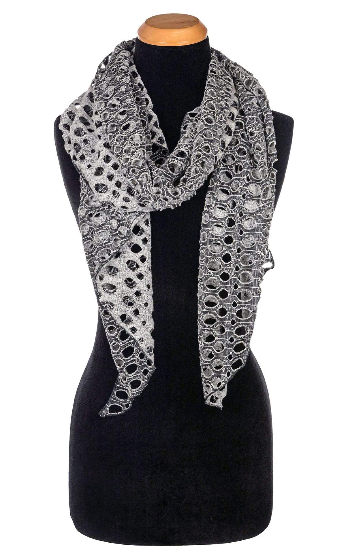 Women’s  Large Handkerchief Scarf, Wrap on Mannequin shown looped in half around neck | Lunar Landing, a black and neutral knit with curled edges surrounding holes| Handmade in Seattle WA | Pandemonium Millinery