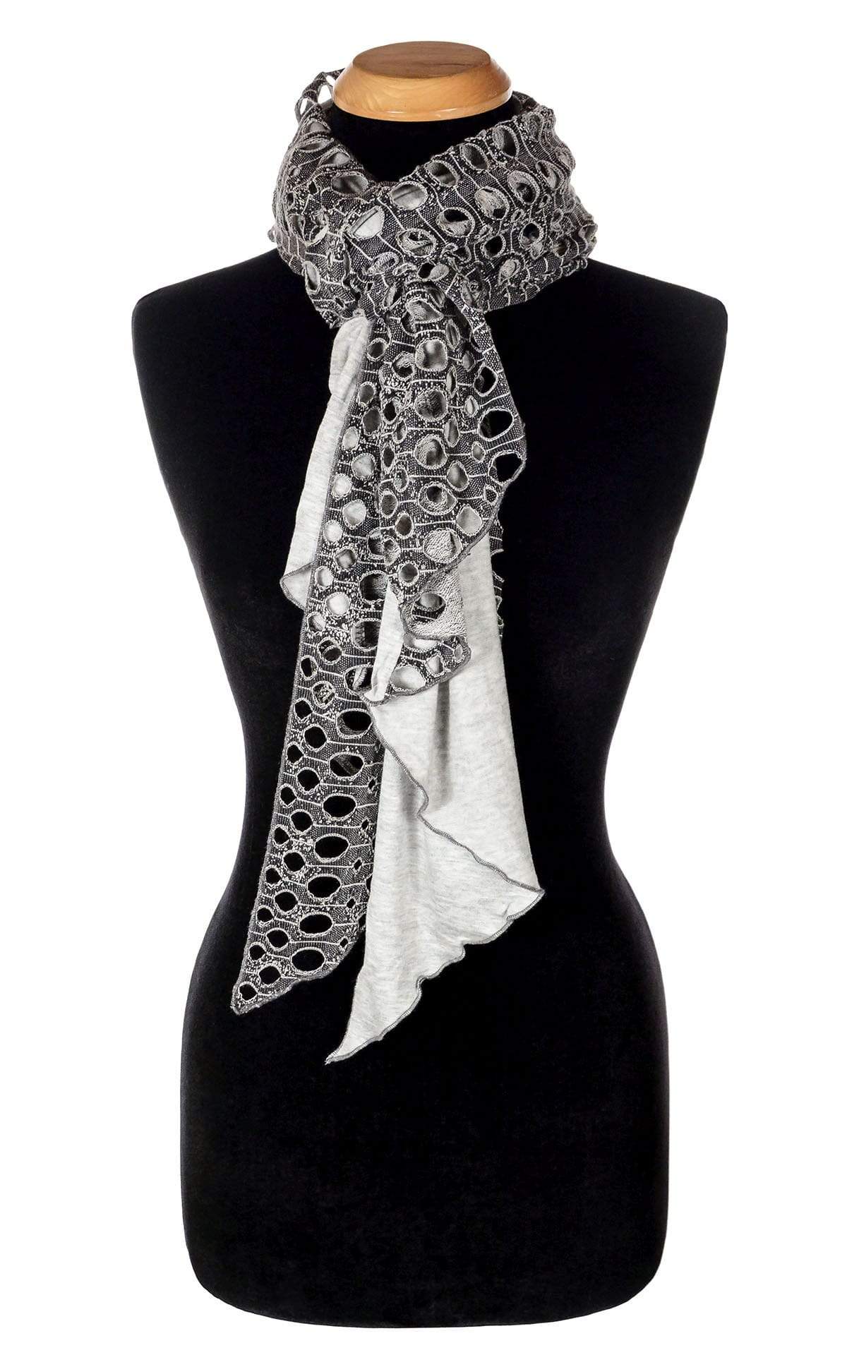 Ladies Two-Tone Handkerchief Scarf on Mannequin | Lunar Landing, a black and neutral knit with curled edges surrounding holes, paired with a light-weight Silver Gray Jersey Knit tied in loop | Handmade in Seattle WA | Pandemonium Millinery