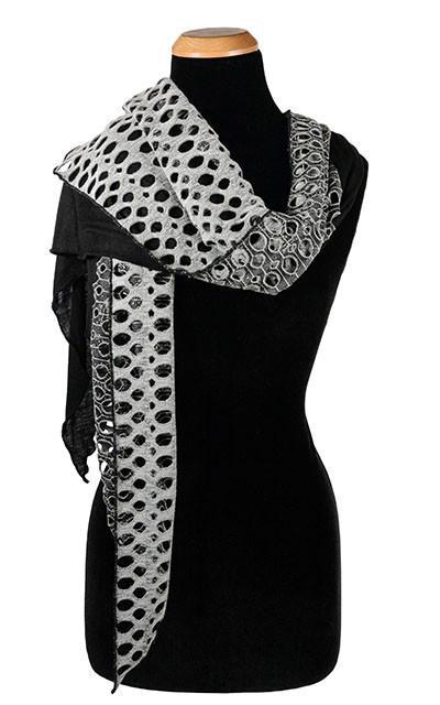 Women's Two-Tone Handkerchief Scarf on Mannequin tossed over shoulder | Lunar Landing, a black and neutral knit with curled edges surrounding holes, paired with a light-weight black Jersey Knit | Handmade in Seattle WA | Pandemonium Millinery