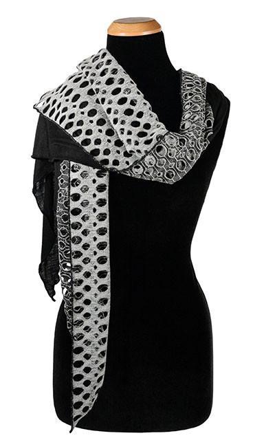 Women&#39;s Two-Tone Handkerchief Scarf on Mannequin tossed over shoulder | Lunar Landing, a black and neutral knit with curled edges surrounding holes, paired with a light-weight black Jersey Knit | Handmade in Seattle WA | Pandemonium Millinery