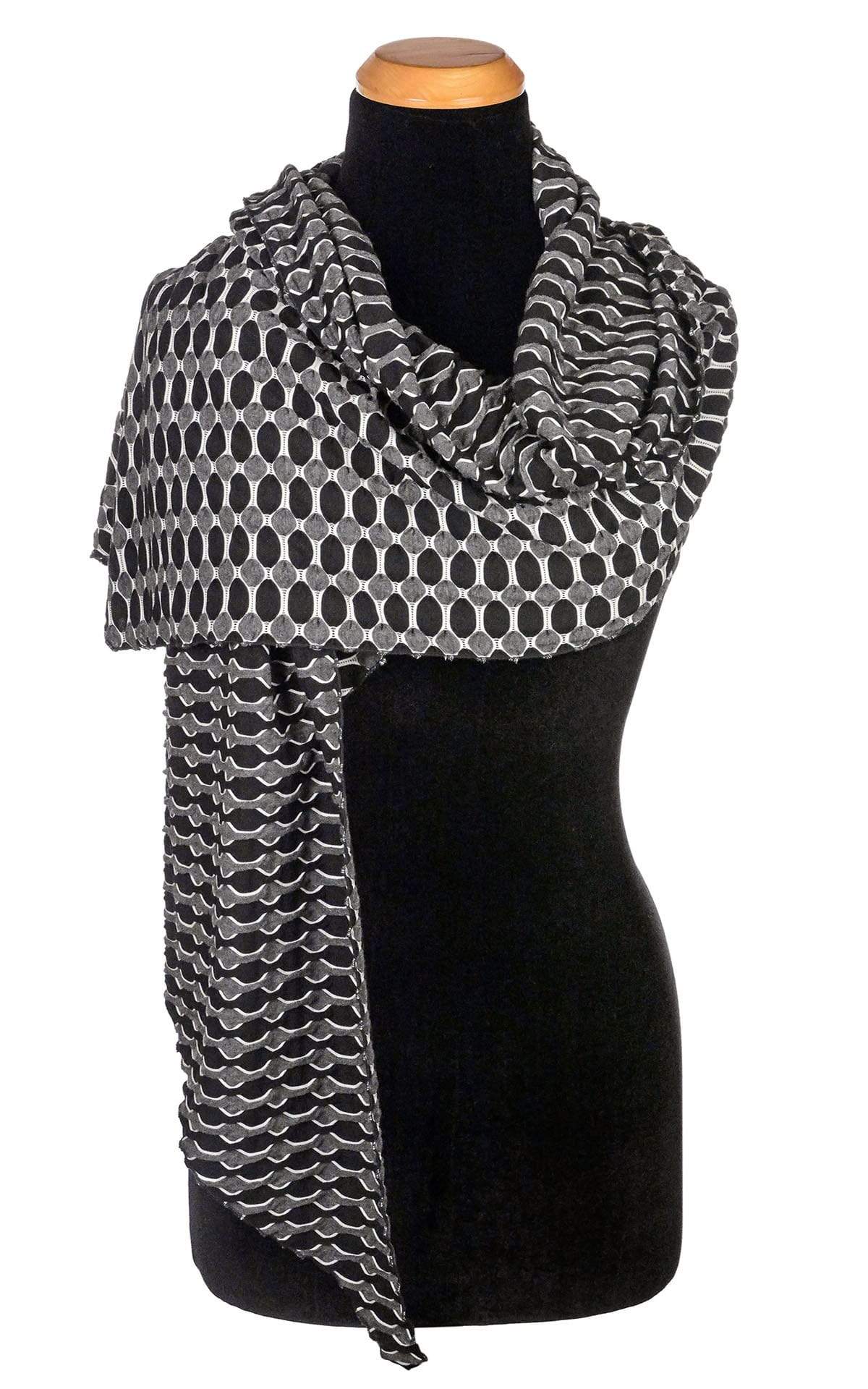 Women’s  Large Handkerchief Scarf, Wrap on Mannequin shown draped over shoulder | Lunar and Solar Eclipse, black knit with white lattice patterning exposing sections of gray and white| Handmade in Seattle WA | Pandemonium Millinery