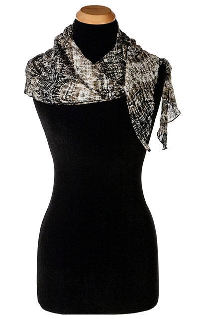 Women’s Large Handkerchief Scarf, Wrap on Mannequin tossed over shoulder  | Shown in snake multi-tonal print on lace, black, brown, and cream | Handmade in Seattle WA | Pandemonium Millinery