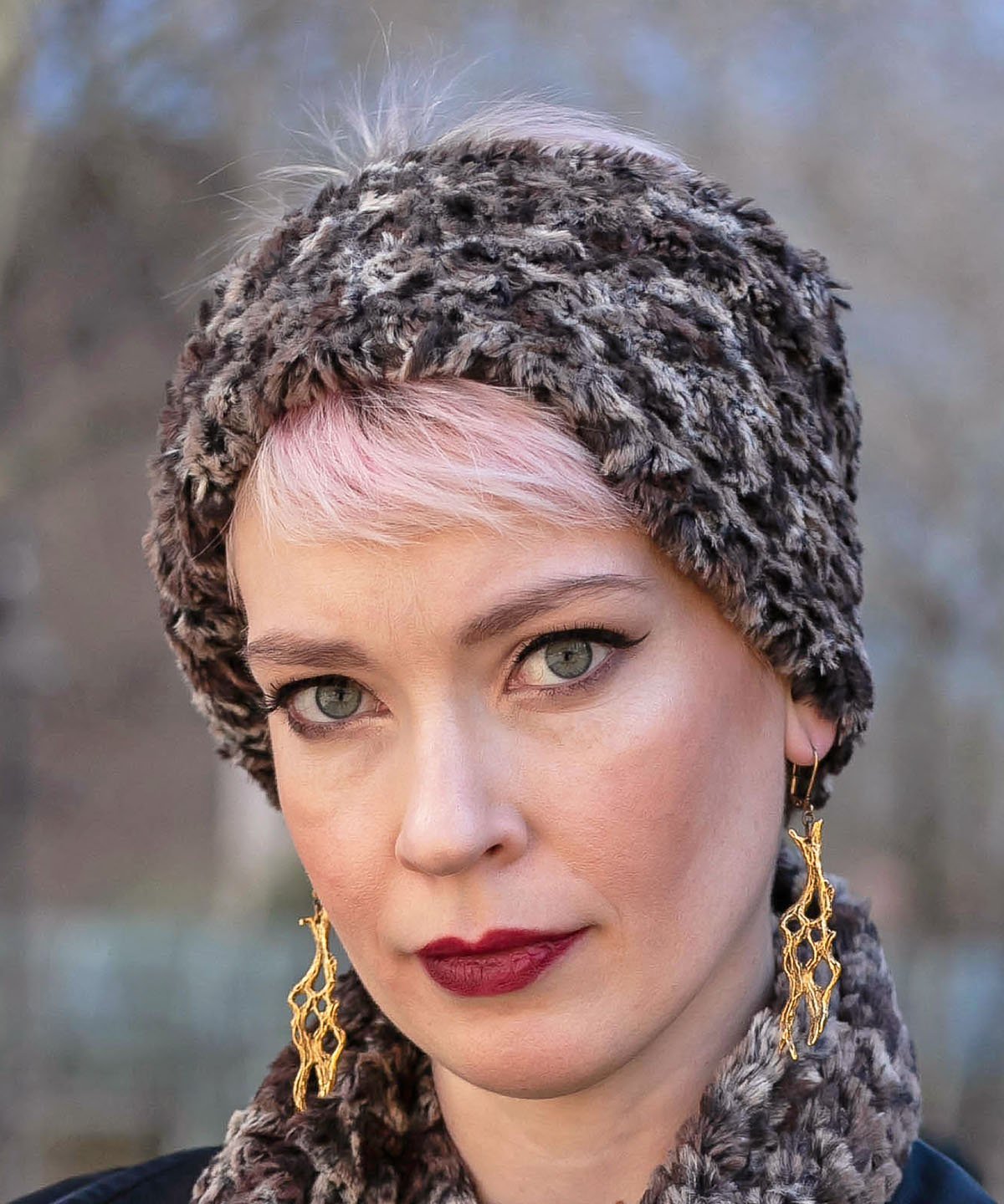 Product shot of Headband, Ear and Neck Warmer with feather trim | Calico, brown, chocolate and Ivory Faux Fur | Handmade by Pandemonium Millinery Seattle, WA USA