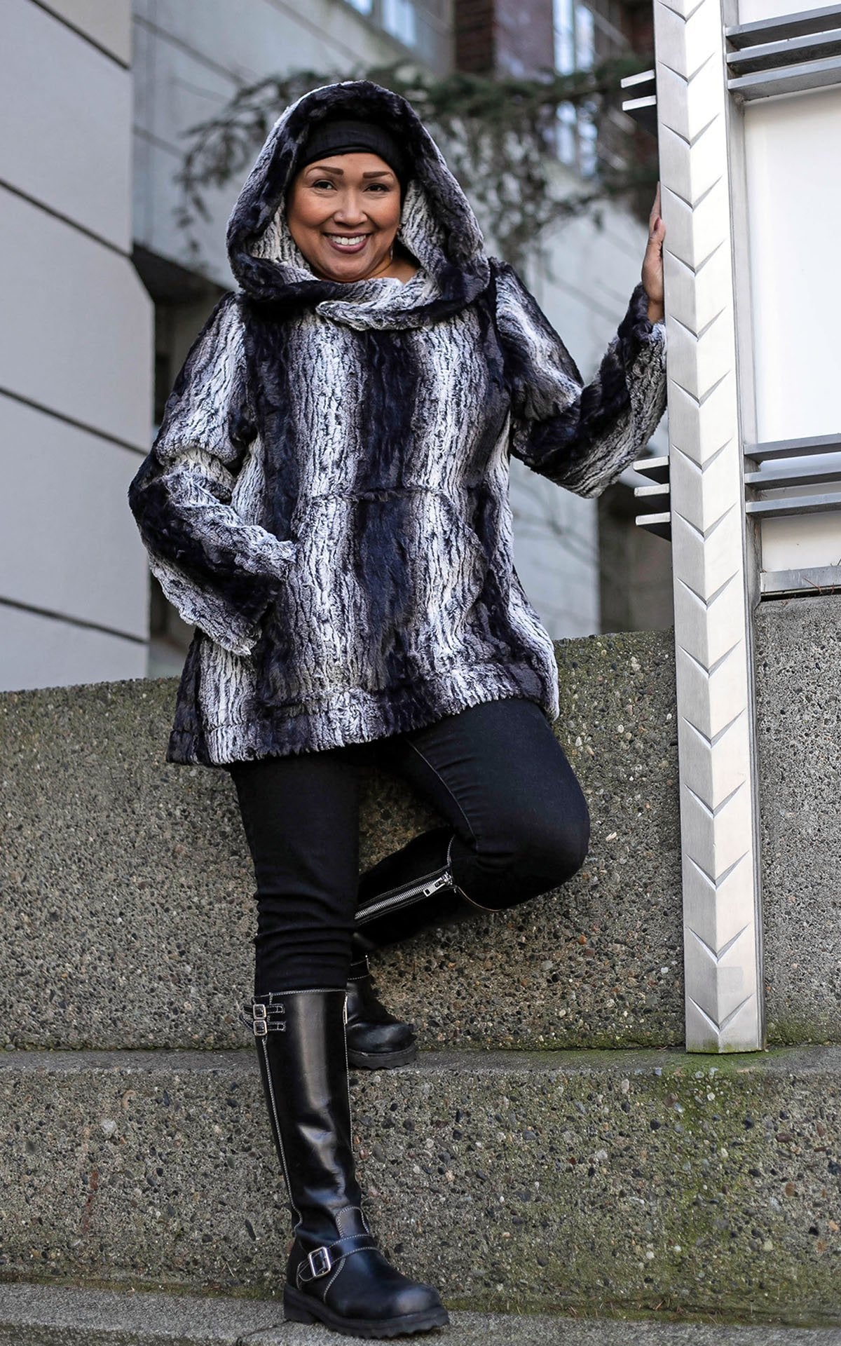 Woman wearing Hoody Lounger with hood up | Luxury Faux Fur in Smouldering Sequoia, Black and White Vertical Stripes | Handmade By Pandemonium Millinery | Seattle WA USA