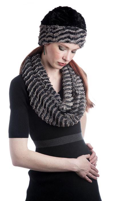 Women looking down wearing a reversible beanie hat and Infinity Scarf | Desert Sand in Charcoal embossed faux fur with light and dark grays | Handmade in Seattle WA | Pandemonium Millinery