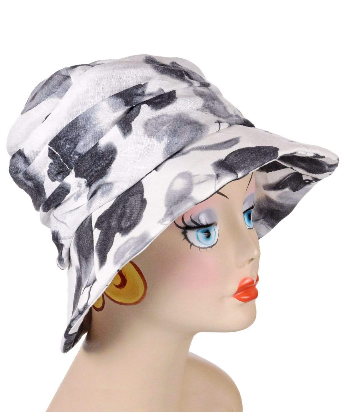 woman wearing matching bag with Krystyne Bucket Hat in Black and White Floral Linen Handmade in Seattle WA by Pandemonium Millinery USA
