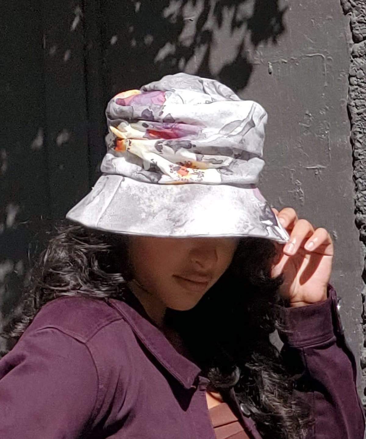woman modeling Krystyne Bucket Hat in Colorful Floral Linen Handmade in Seattle WA by Pandemonium Millinery USA