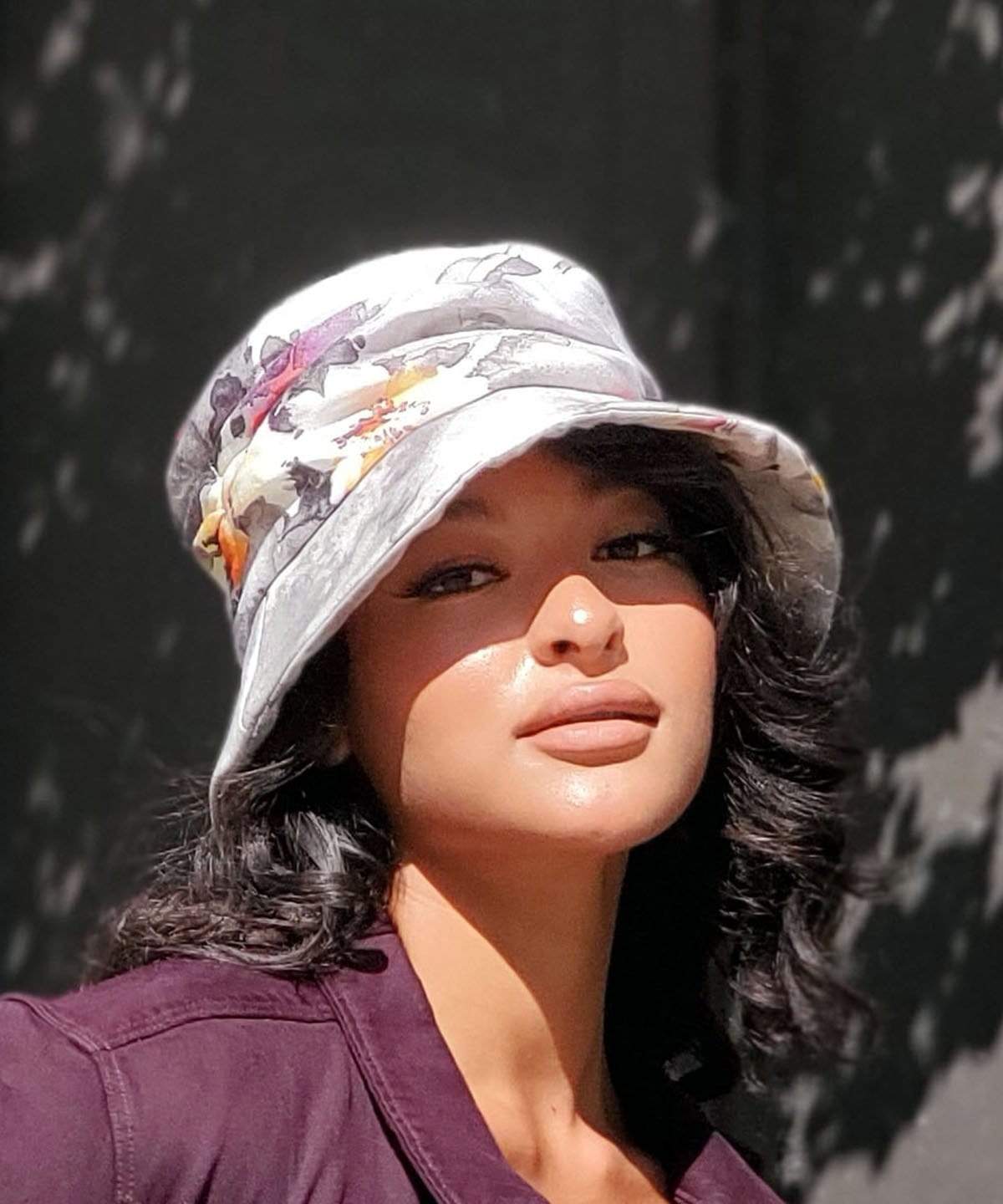 woman modeling Krystyne Bucket Hat in Colorful Floral Linen Handmade in Seattle WA by Pandemonium Millinery USA