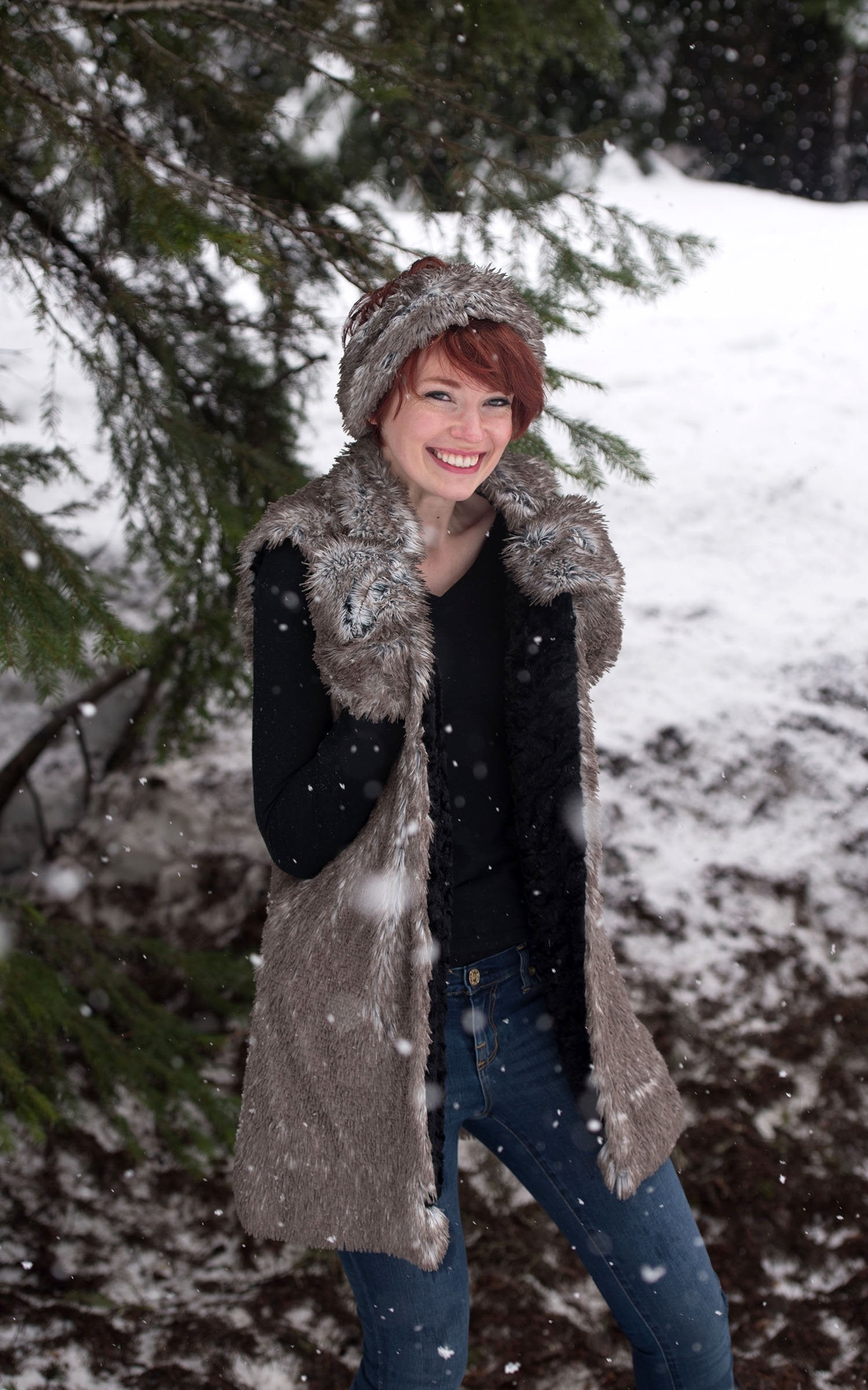 Model in snow wearing Mandarin Vest Long | Arctic Fox Long Hair Faux Fur with Cuddly Black Faux Fur | By Pandemonium Millinery | Handmade in Seattle WA USA