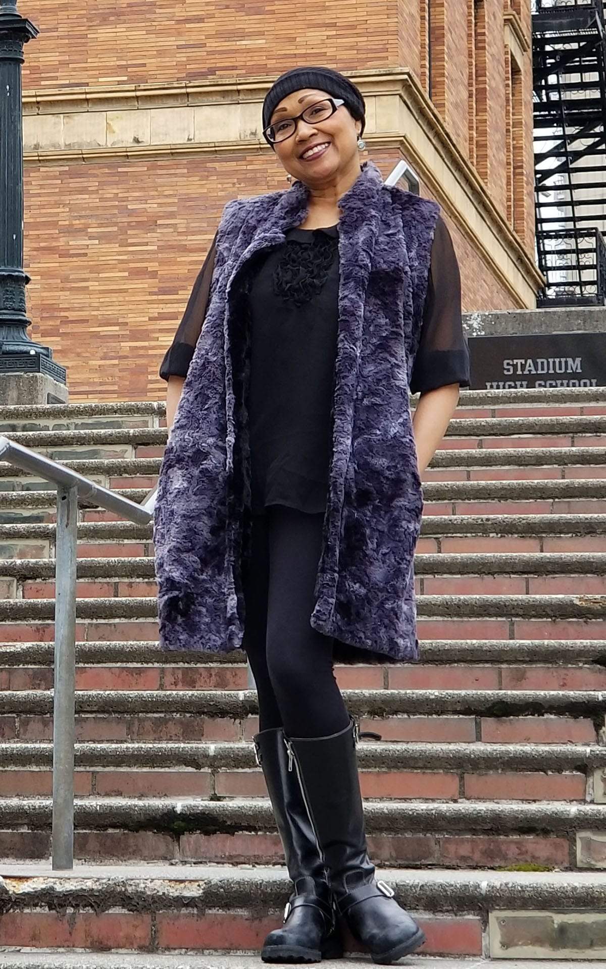 Model on the stairs wearing Mandarin Vest Long | Highland in Sky Denim and Gray with Faux Fur and Cuddly Black Faux Fur | Handmade in Seattle WA | Pandemonium Millinery