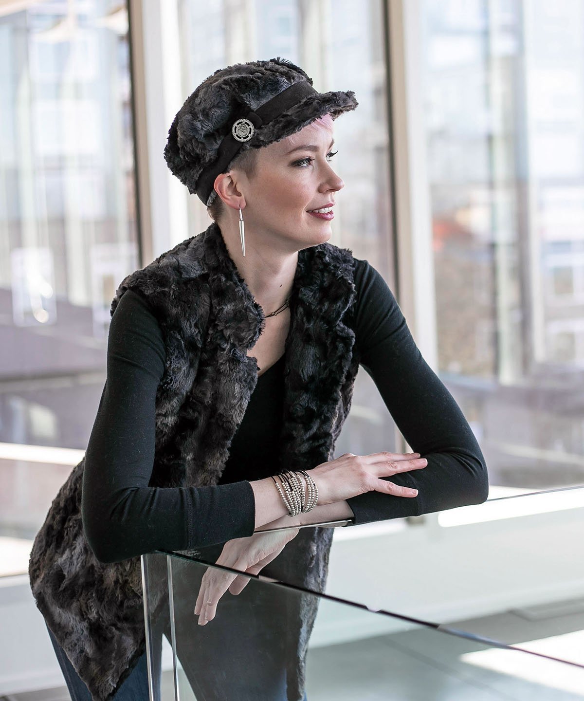 Model leaning on a glass railing wearing in Mandarin Vest Short | Highland in Sky Denim and Gray Faux Fur and Cuddly Black Faux Fur | Handmade in Seattle WA | Pandemonium Millinery