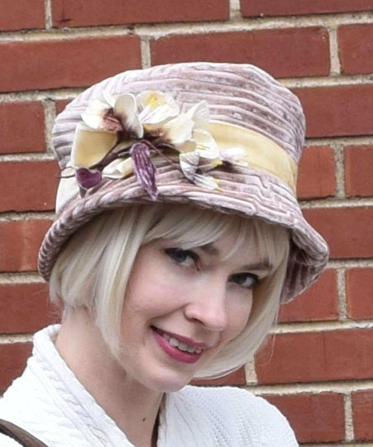 Headshot of Modeling wearing Molly Hat Chenille in Cherry Blossom with  Cream Velvet Flower Brooch | Handmade By Pandemonium Millinery | Seattle WA USA