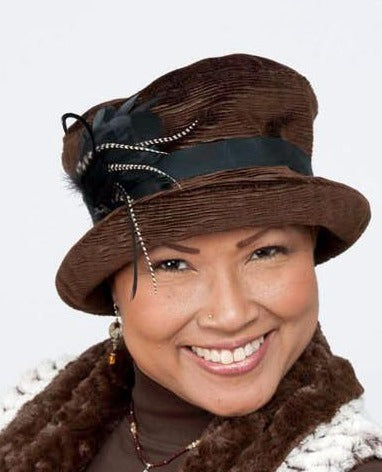 Model wearing Molly Bucket Style Hat Cohen in Chocolate Upholstery with Black Grosgrain featuring  Grizzly Feather Brooch | Handmade By Pandemonium Millinery | Seattle WA USA